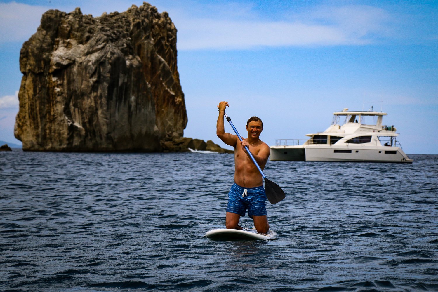 Paddle boarding near the Playgrounds catamaran off Tamarindo, Costa Rica