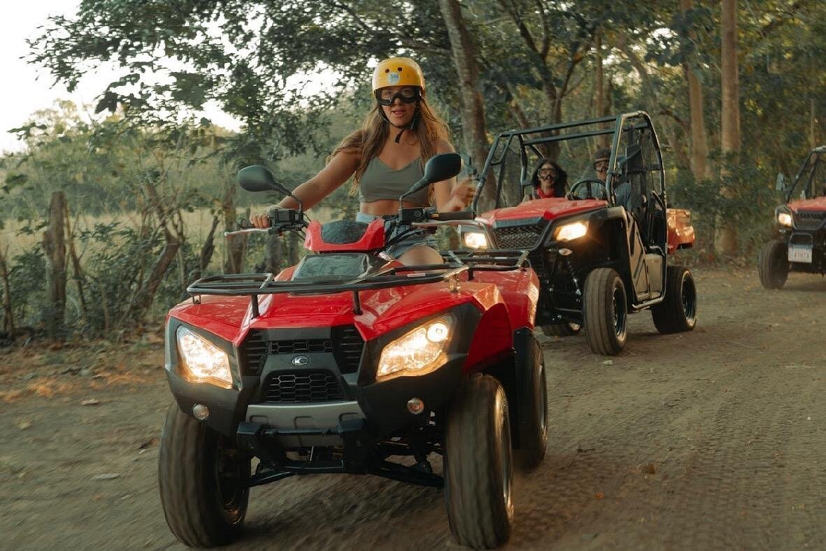 Group riding ATVs on a dirt road near Tamarindo, Costa Rica