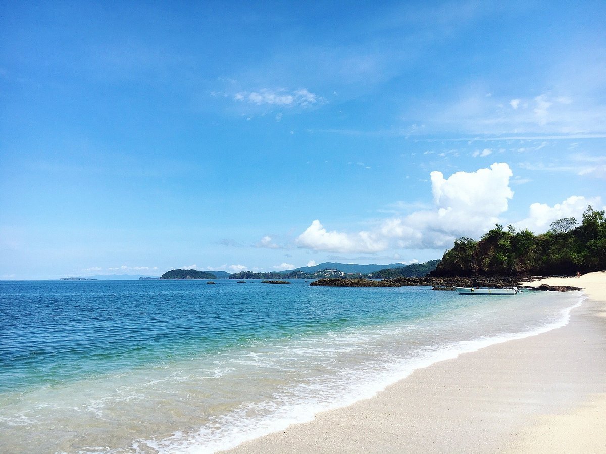 Small boat anchored in a calm cove along the Guanacaste coast near Tamarindo